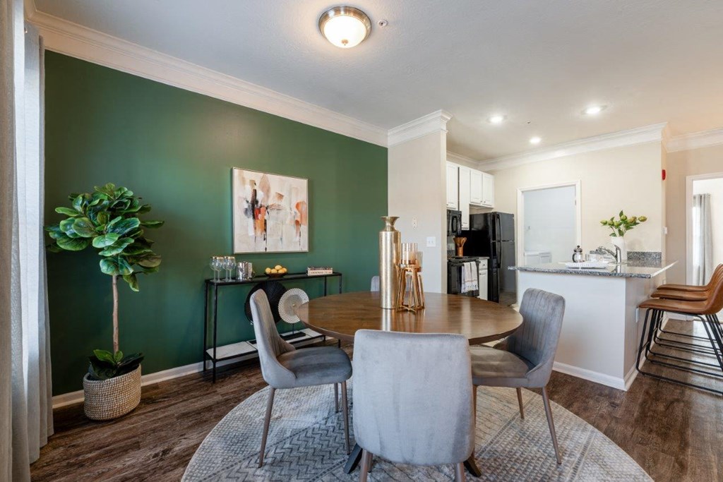 a dining room and kitchen with a table and chairs