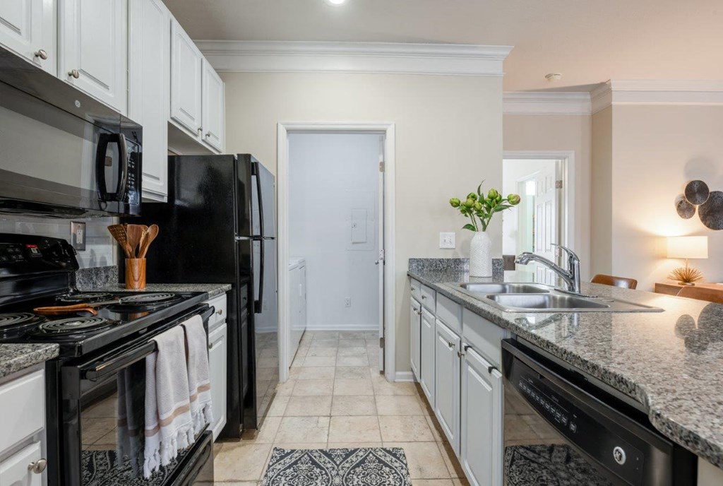 a kitchen with black appliances and granite counter tops