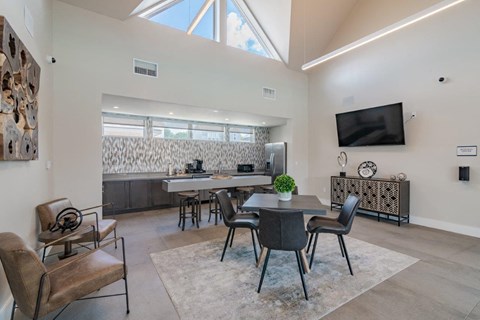 a living room with a table and chairs and a television