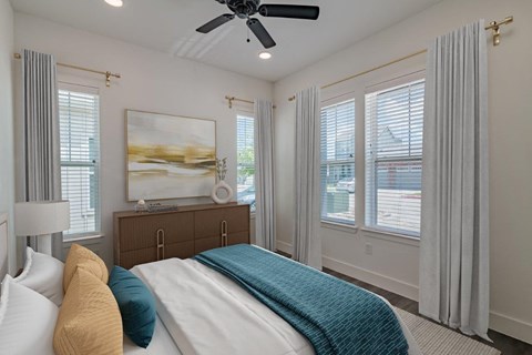 a bedroom with a bed and a ceiling fan