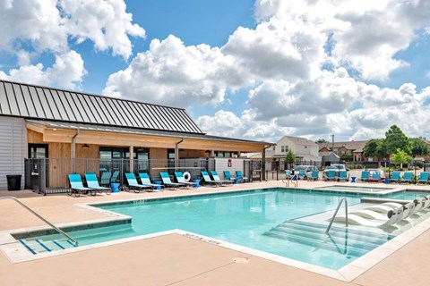the swimming pool at the resort combines a resort style pool with lounge chairs