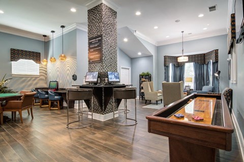 a game room with a pool table and chairs