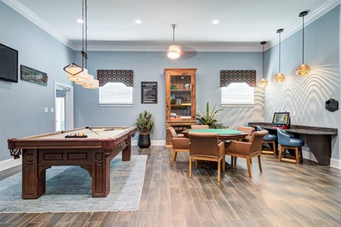 a game room with a pool table and billiards