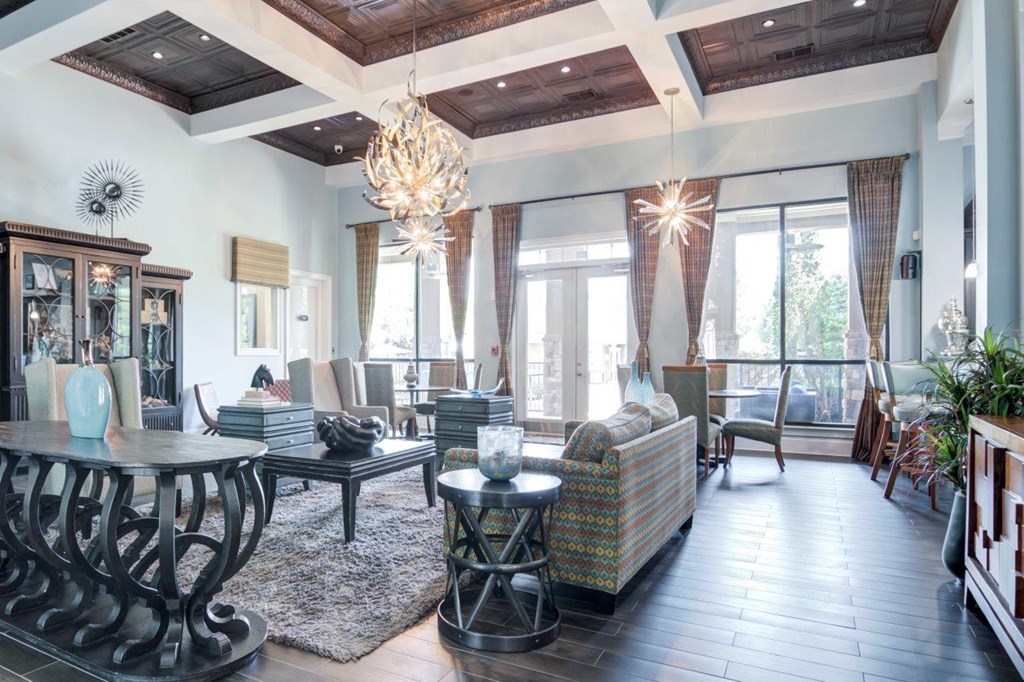 a large living room with a chandelier and a table
