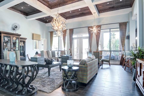 a large living room with a chandelier and a table