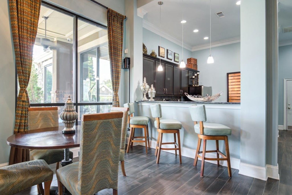 a kitchen and dining area with a bar and a table