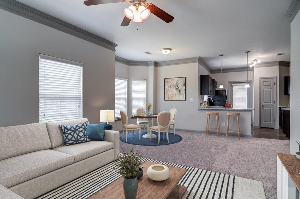a living room with a couch and a table with chairs