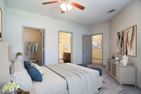 a bedroom with a large bed and a ceiling fan