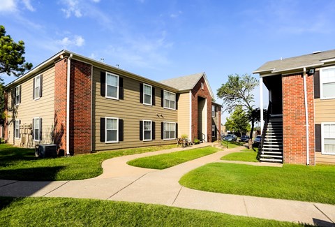 A sunny day at a residential area with houses and green lawns.