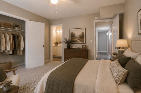 A bedroom with a large bed and a painting on the wall.