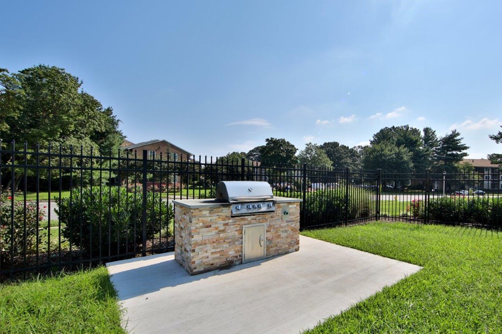 A small building with a black fence in front of it.