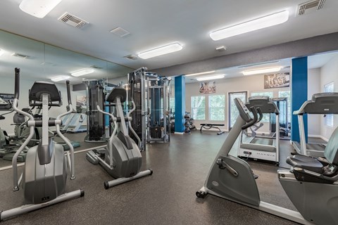 a gym with cardio machines and other exercise equipment at the community center