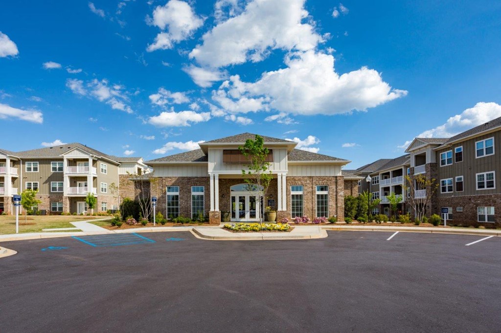 an empty parking lot in front of an apartment building