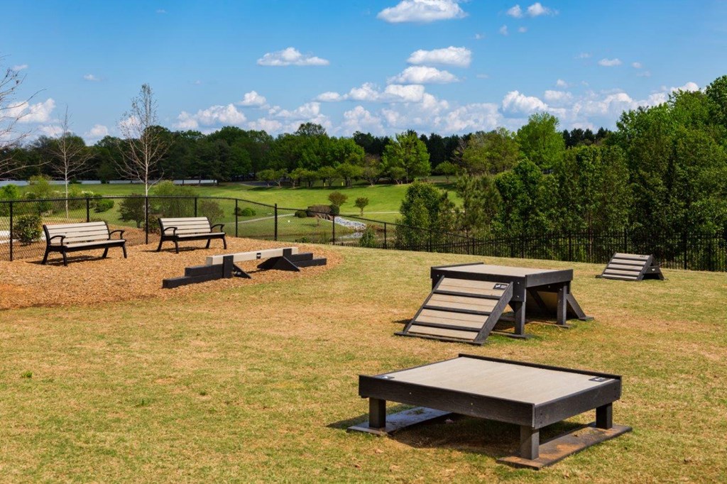 a group of benches and picnic tables in a park