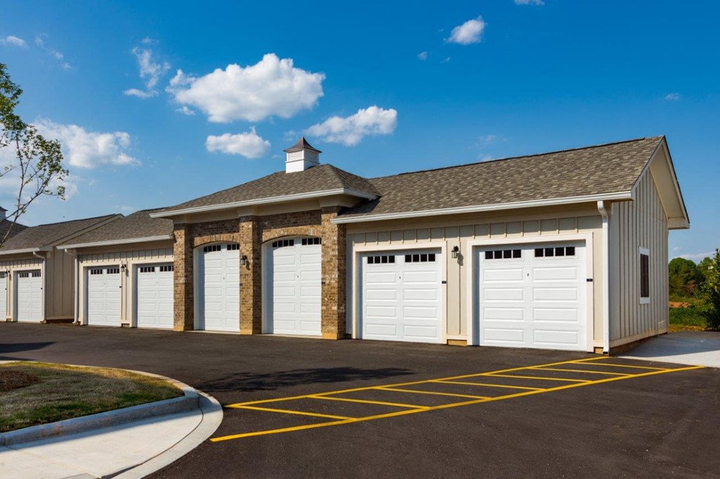a large garage with white doors and a roof