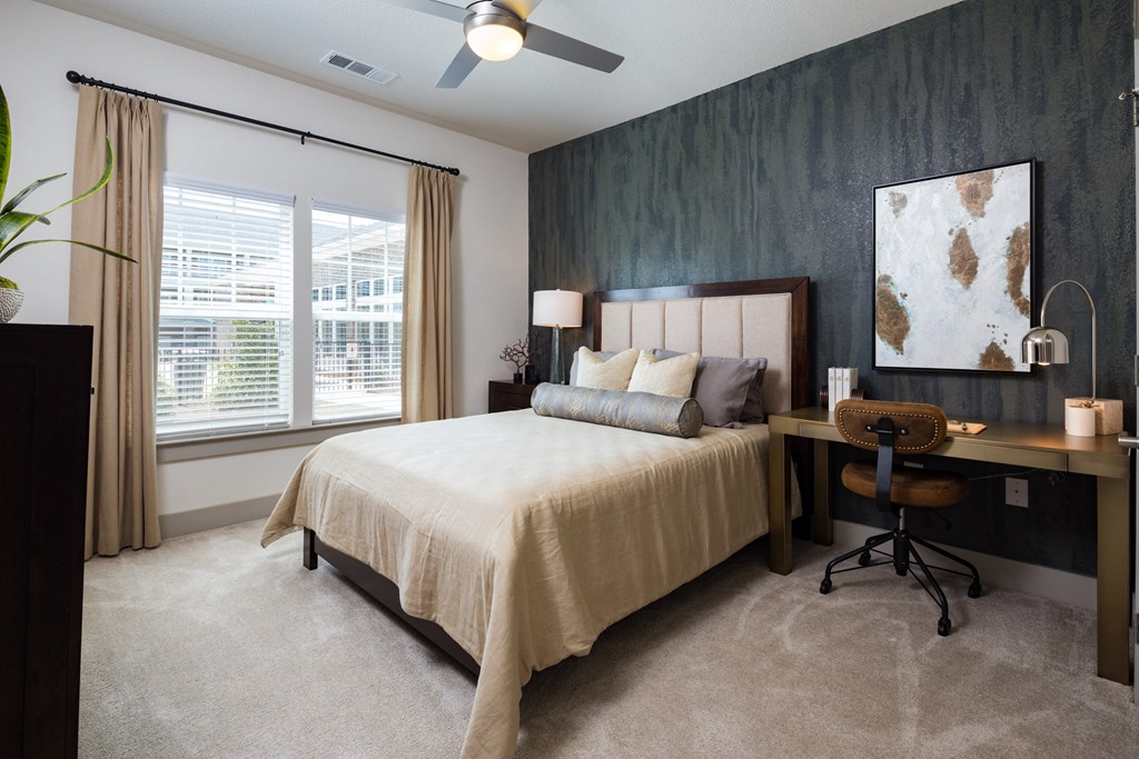 a bedroom with a bed and a desk