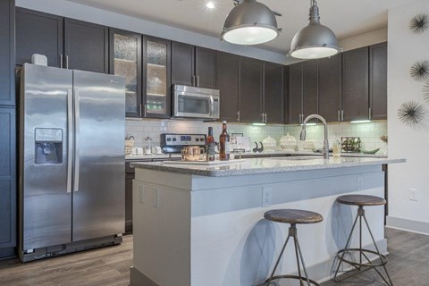 a kitchen with a counter top and a refrigerator