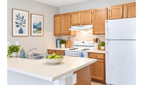 A kitchen with wooden cabinets and a white refrigerator.