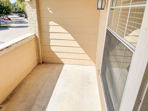 A sunny day with a shadow of a tree on a wall.