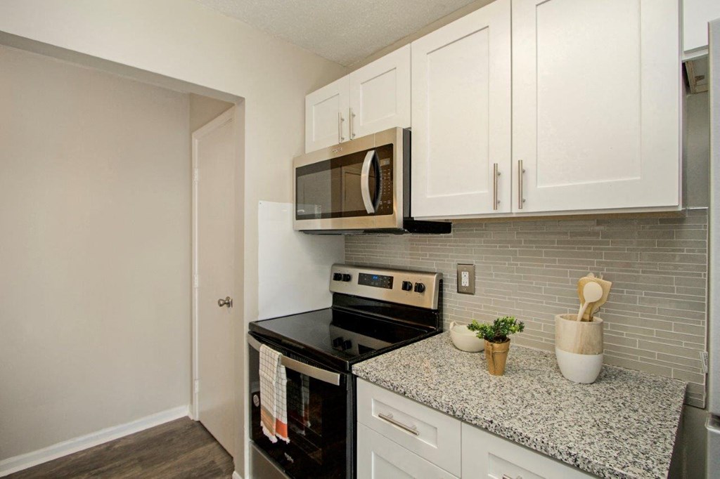 White Kitchen with Black Appliances and Granite Countertops