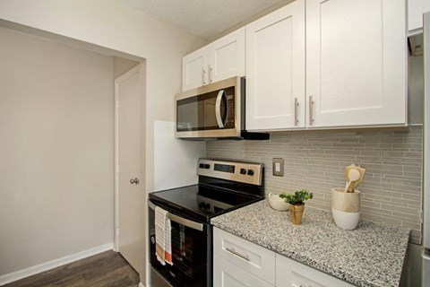 White Kitchen with Black Appliances and Granite Countertops
