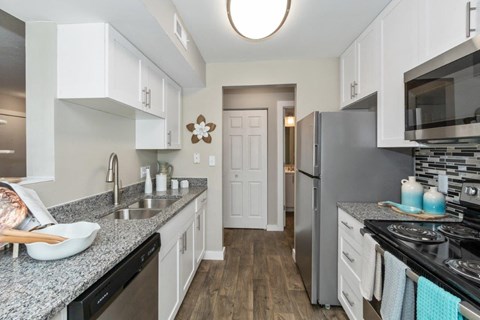 a kitchen with granite counter tops and stainless steel appliances