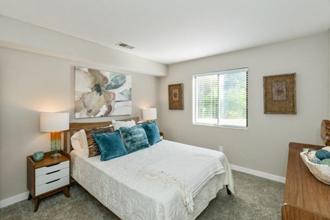 a bedroom with a bed and a window