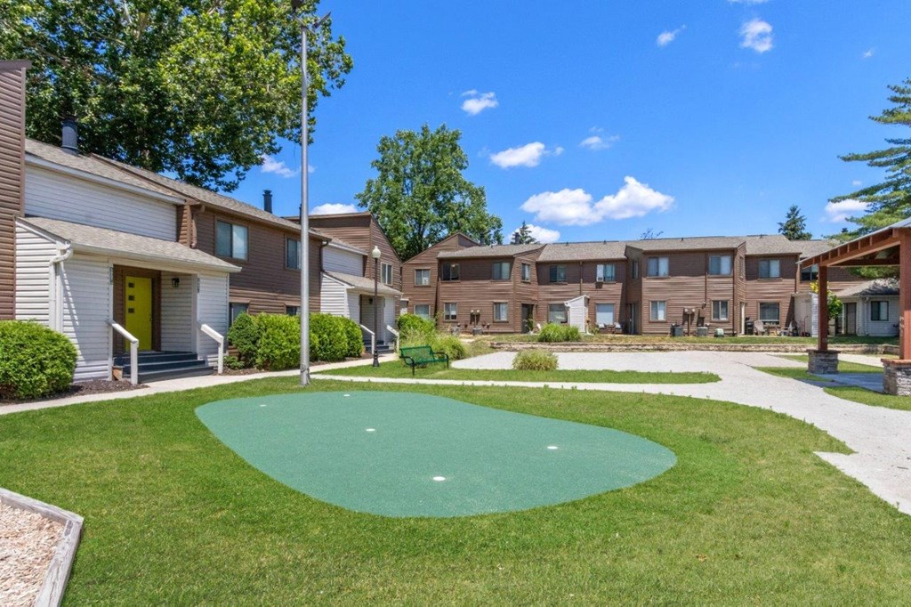 a putting green in the middle of an apartment complex
