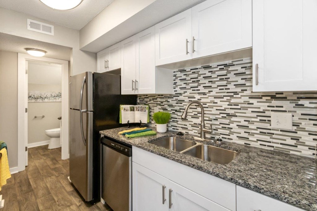 a kitchen with stainless steel appliances and granite counter tops