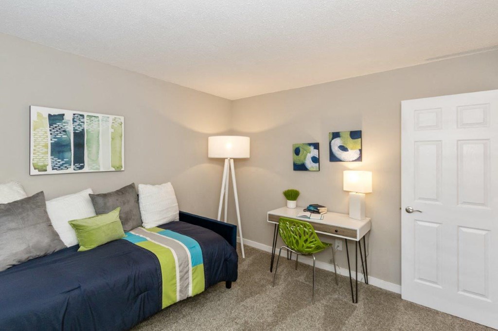 a bedroom with a bed and a desk