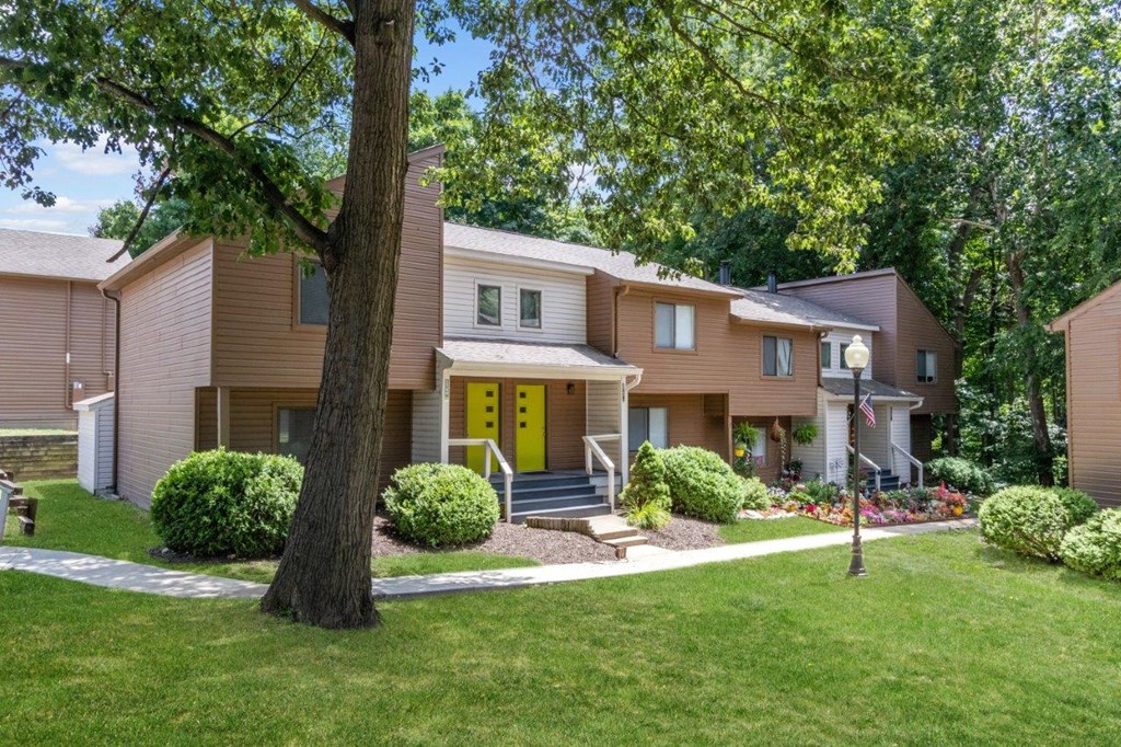 the front of a house with a yellow door