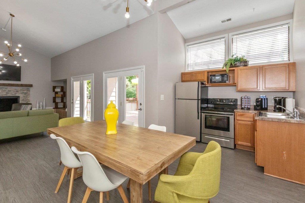 a kitchen and dining room with a table and chairs