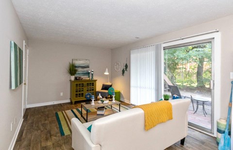 a living room with a large window and a couch