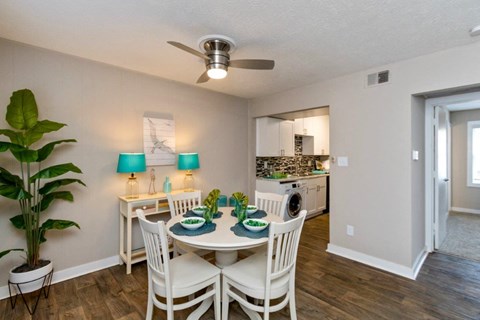 a dining room with a table and chairs and a kitchen