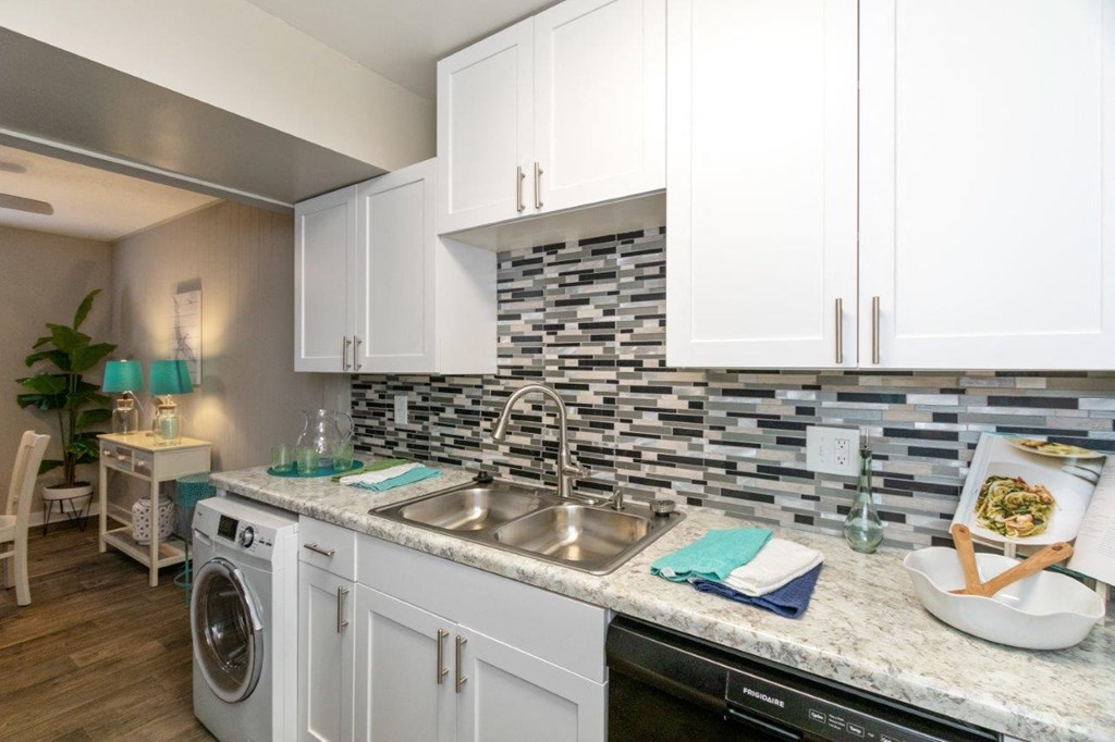 a kitchen with white cabinets and a sink