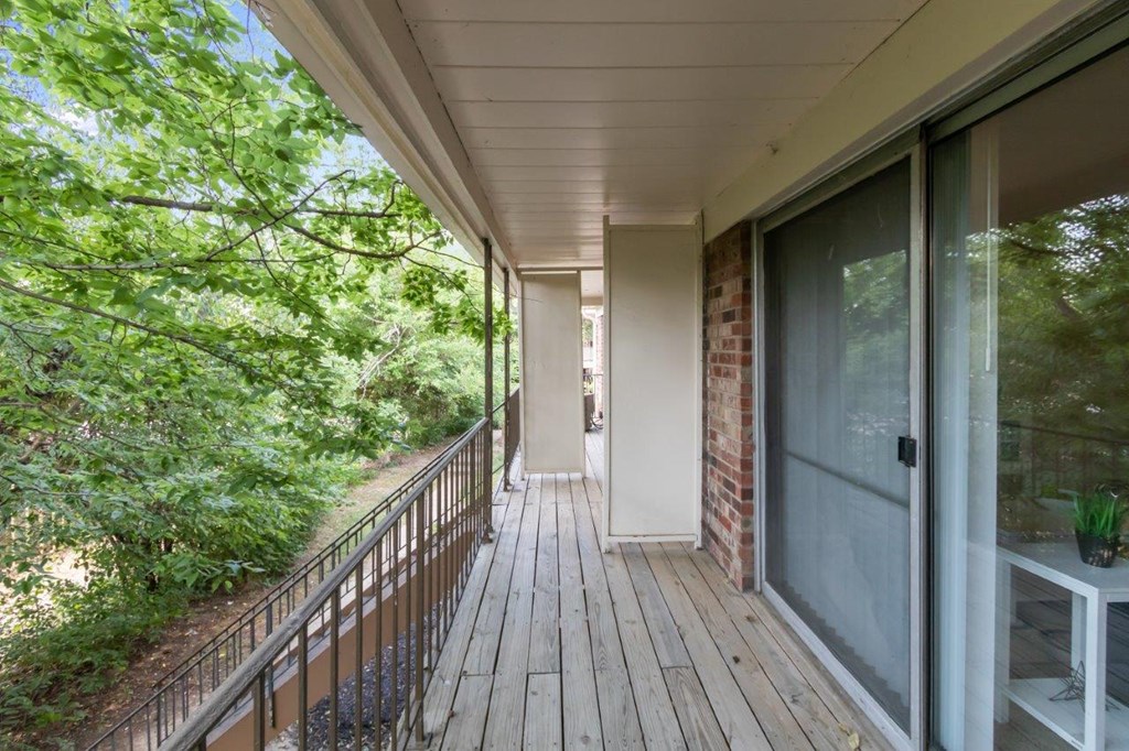 the view from the porch of a home with a large glass door