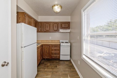 a kitchen with colorful toothbrushes hanging from the wall