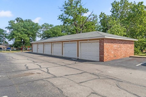 a row of garages in front of a brick building