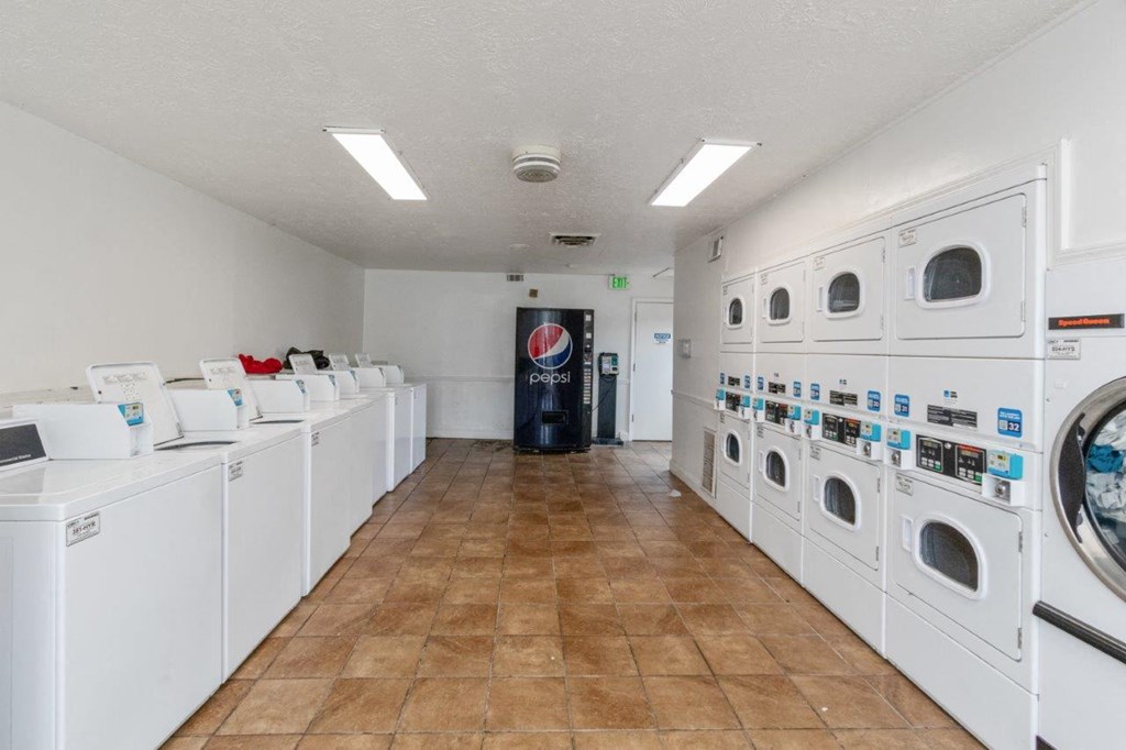 a washer and dryer room with lots of washing machines