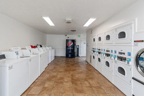 a washer and dryer room with lots of washing machines