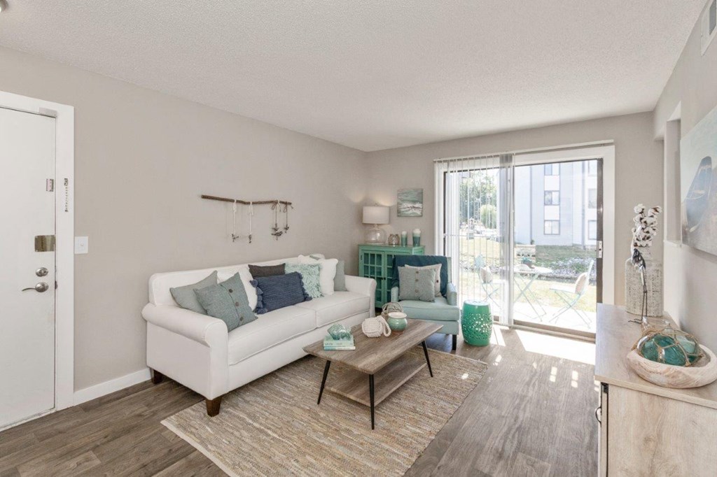 a staged living room with a sliding glass door