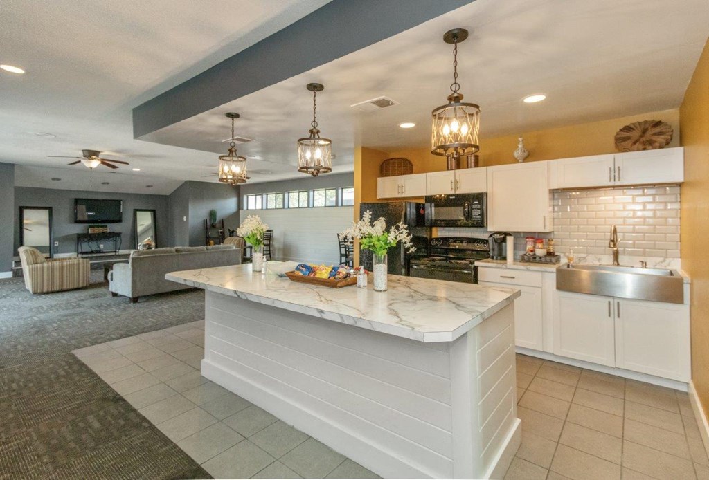 a large kitchen with a center island and a living room