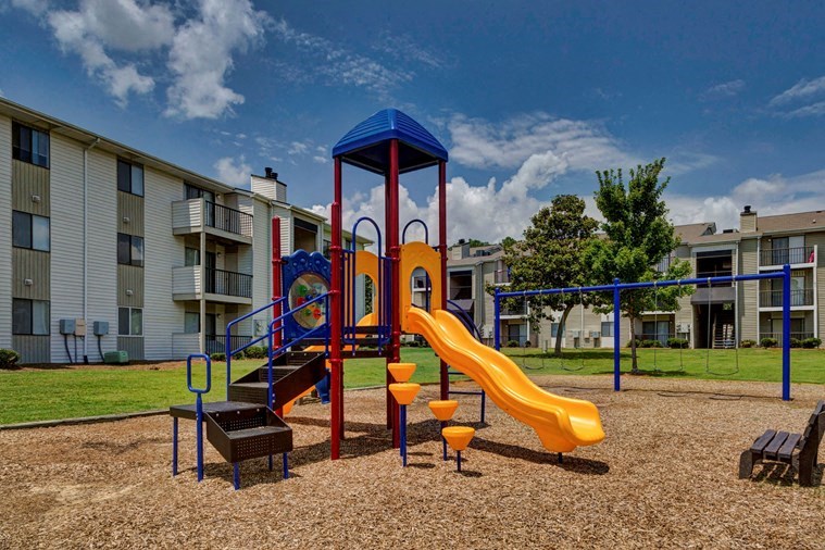 our apartments have a playground with slides and a picnic table