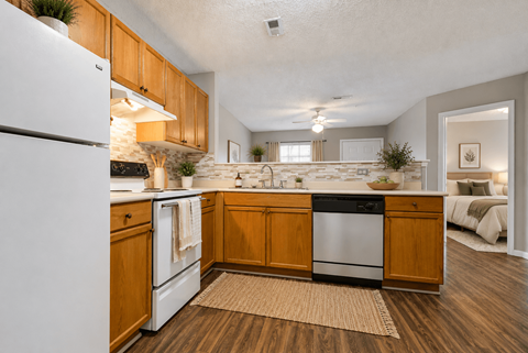 A kitchen with wooden cabinets and a white refrigerator.