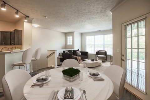 a living room and dining room with a white table and chairs