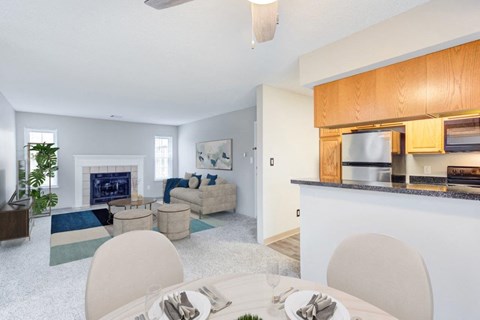 a living room and dining room with a table and chairs