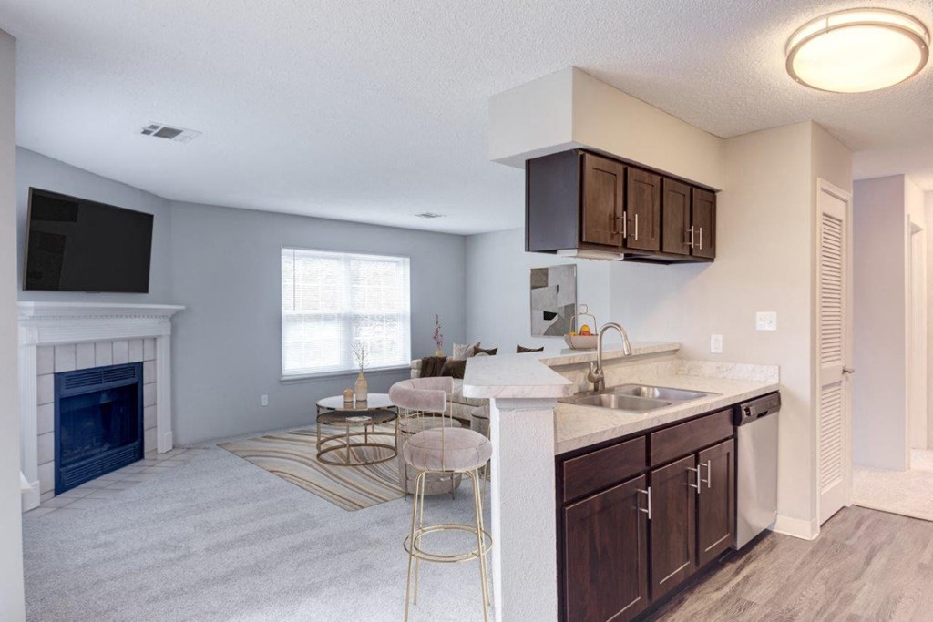 a living room with a kitchen and a fireplace