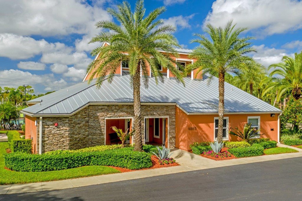 A house with a red door and a stone wall.