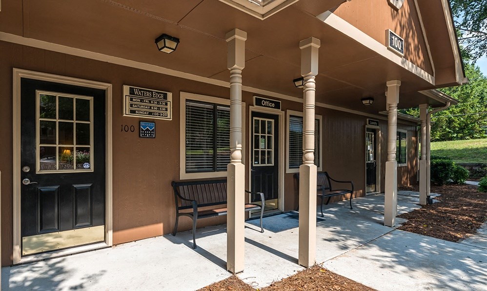 a building with a porch and benches outside of it