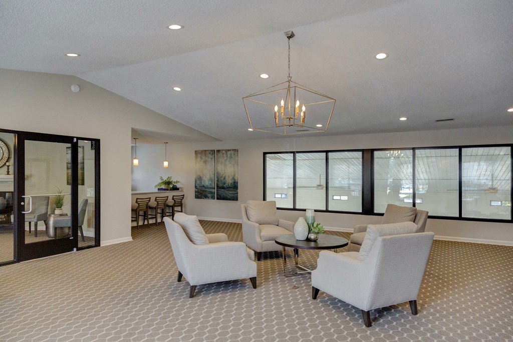 a lobby with couches and chairs and a chandelier